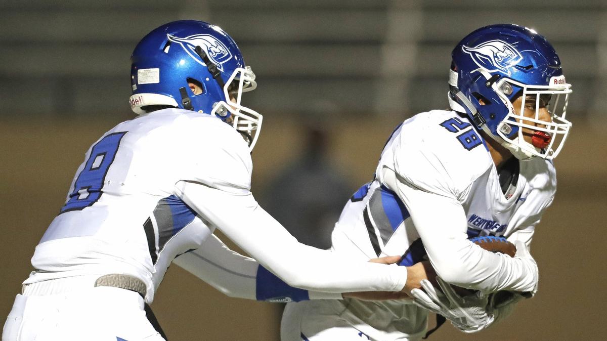 Weatherford quarterback Ken Seals (8) hands the ball to running back Aeneaus Gray (28) during the first half of a high school football game at Pennington Field in Euless, Texas, Friday, Nov. 09, 2018. The Weatherford Roos led the Raiders 14-9 at the half. (Special to the Star-Telegram Bob Booth)

