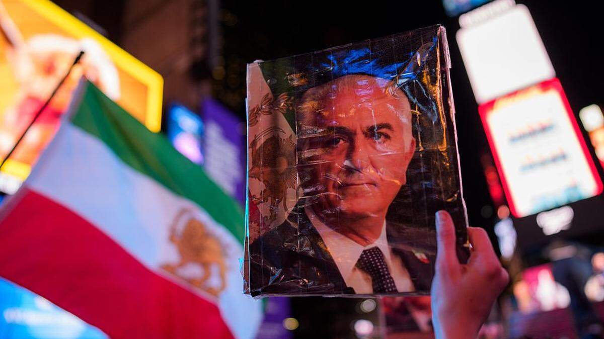 A person holds an image of Reza Pahlavi during a “Freedom for Iran” rally in Times Square on March 2, 2026, in New York.