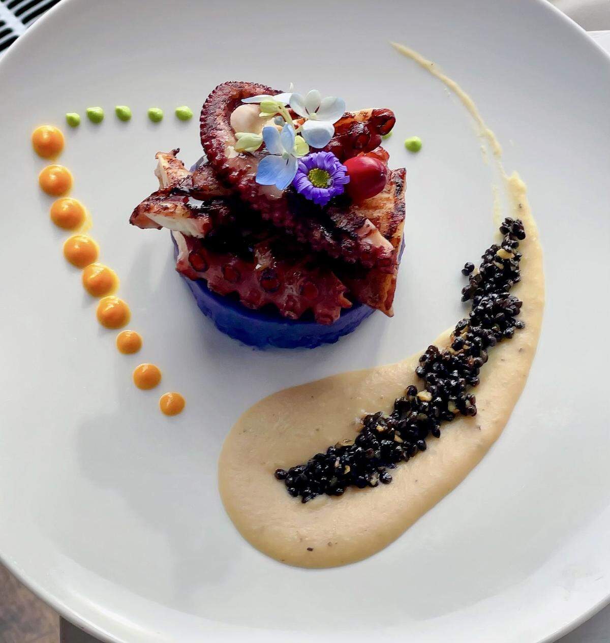 Grilled octopus with purple mashed-potato-bean puree and lentils at Acquario Italian.