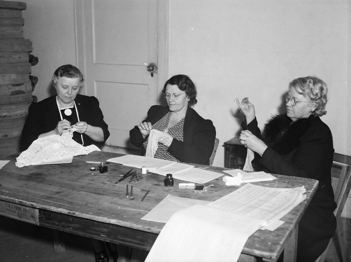 April 8, 1941: Left to right are Mrs. M.A. Elliott, 1616 Carleton Ave., election judge; Mrs. P.L. Forbes, 4613 Washburn Ave.; and Mrs. P. F. Middleton, 4700 Birchman Ave. Mrs. Elliott is crocheting while the other two darn socks. These election officials at the fire hall box volunteered to darn the firemen at Station 18’s socks for them after a City Council election.