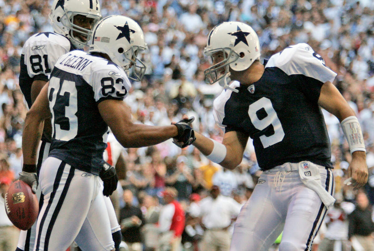 Dallas Cowboys quarterback Tony Romo (9) and receiver Terry Glenn (83) celebrate after Glenn’s touchdown reception, as teammate Terrell Owens looks on in the second quarter of an NFL football game against the Tampa Bay Buccaneers in Irving, Texas, Thursday, Nov. 23, 2006. The Cowboys won 38-10 with Glenn catching two of Romo’s five touchdown passes. (AP Photo/Tony Gutierrez)