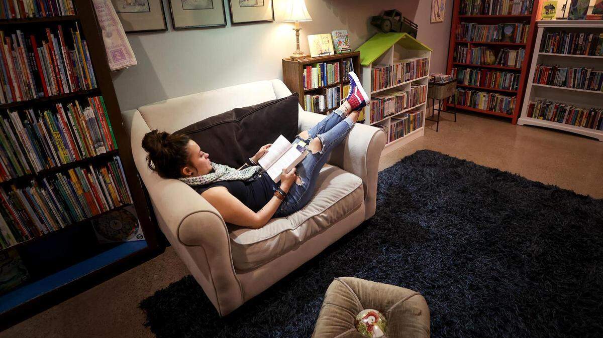 Naomi Emory of Anna reads a book at Monkey and Dog, an independent bookstore in Fort Worth, on Thursday. Saturday is Independent Bookstore Day, and Monkey and Dog will be celebrating along with other bookshops in DFW.