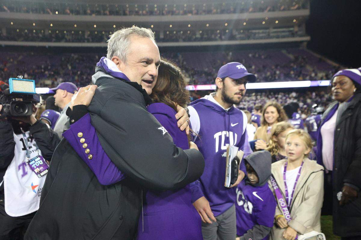 Husband-and-wife Sonny Dykes and Kate Golding hug after TCU beats Iowa State, 62-14, at the Amon G. Carter Stadium in Fort Worth on Saturday, Nov. 26, 2022. The Horned Frogs secured an undefeated regular season.