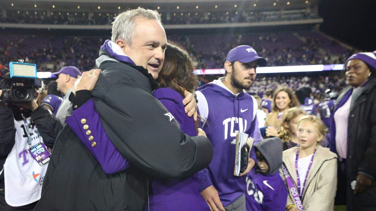 Husband-and-wife Sonny Dykes and Kate Golding hug after TCU beats Iowa State, 62-14, at the Amon G. Carter Stadium in Fort Worth on Saturday, Nov. 26, 2022. The Horned Frogs secured an undefeated regular season.