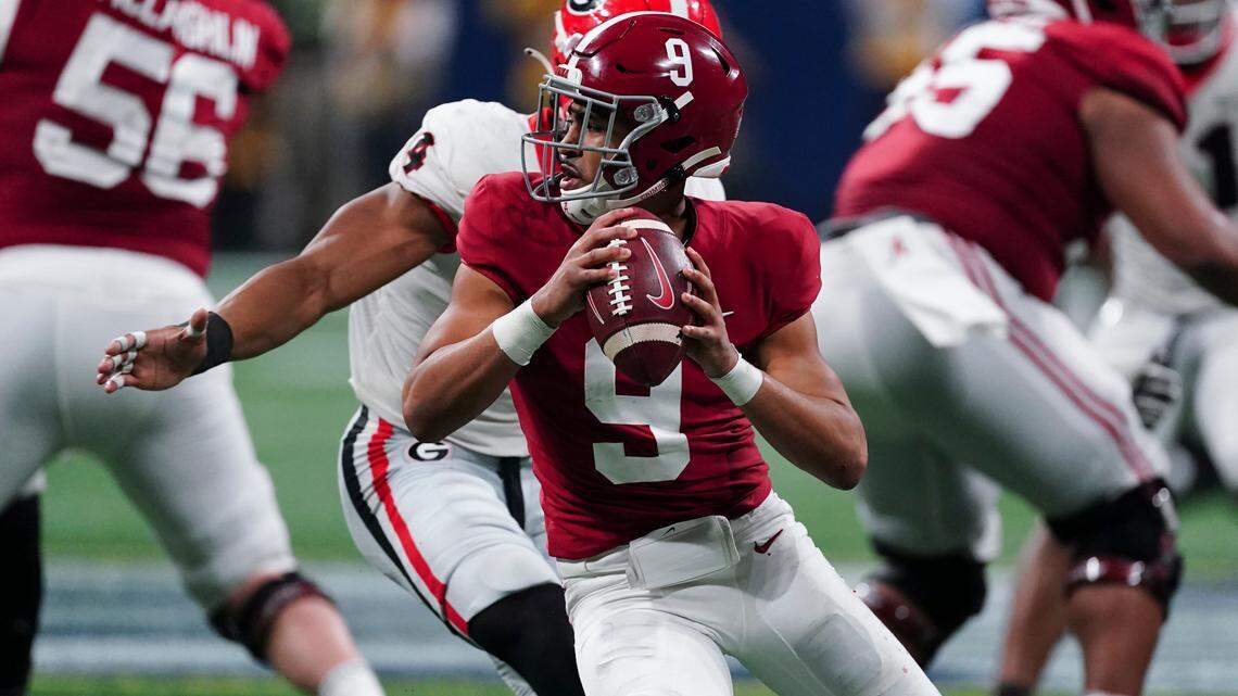 With lucrative NFL contracts just months away, some ask why top players like Alabama quarterback Bryce Young (9) would risk playing Georgia in the college football national title game in Indianapolis Monday night.