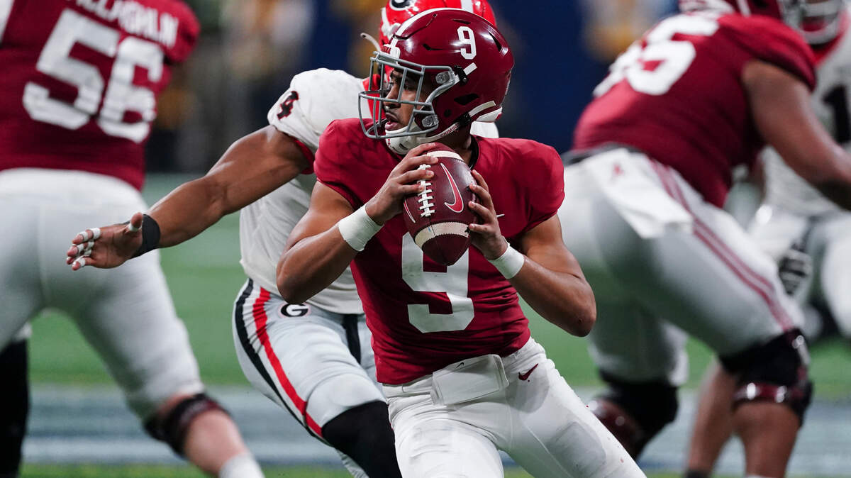 With lucrative NFL contracts just months away, some ask why top players like Alabama quarterback Bryce Young (9) would risk playing Georgia in the college football national title game in Indianapolis Monday night.