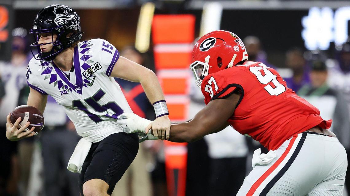 TCU quarterback Max Duggan slips away from Georgia defensive tackle Warren Brinson at the 2023 College Football Playoff National Championship on Monday, January 9, 2023, at SoFi Stadium in Inglewood, Calif.