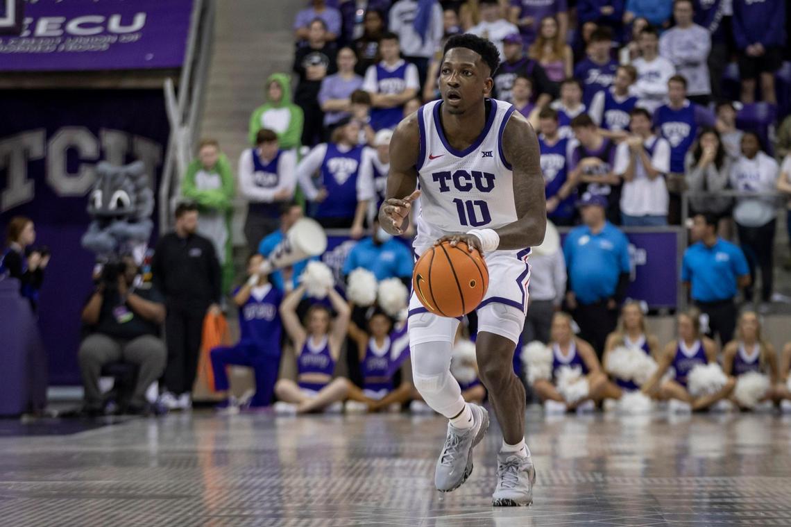 TCU guard Damion Baugh dribbles down the court during their game against Baylor on Saturday Feb. 11, 2023 at Schollmaier Arena in Fort Worth.