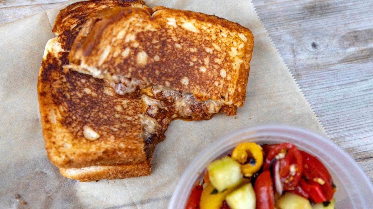 A wagyu sloppy joe served with a blistered pepper cucumber salad from new food truck Cheezy Does It in Fort Worth on Friday, March 9, 2023. Chef Scotty Scott’s vision for the truck centers around cheesy, buttered, hot sandwiches from the griddle.