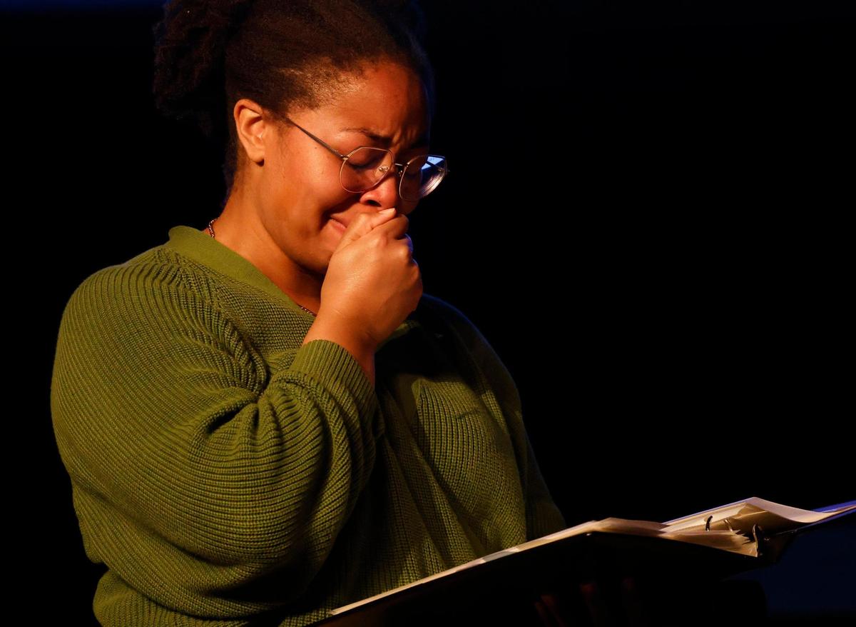 Tajanae Harris tears up as she looks through an album with 100-year-old photos of her family during “The Conversation: A Story in Black and White” in the sanctuary at the Well Church in Keller, Texas, Tuesday, Nov. 12. During the event, Harris met a descendant of the family that owned her relative, Delia, as a slave.
