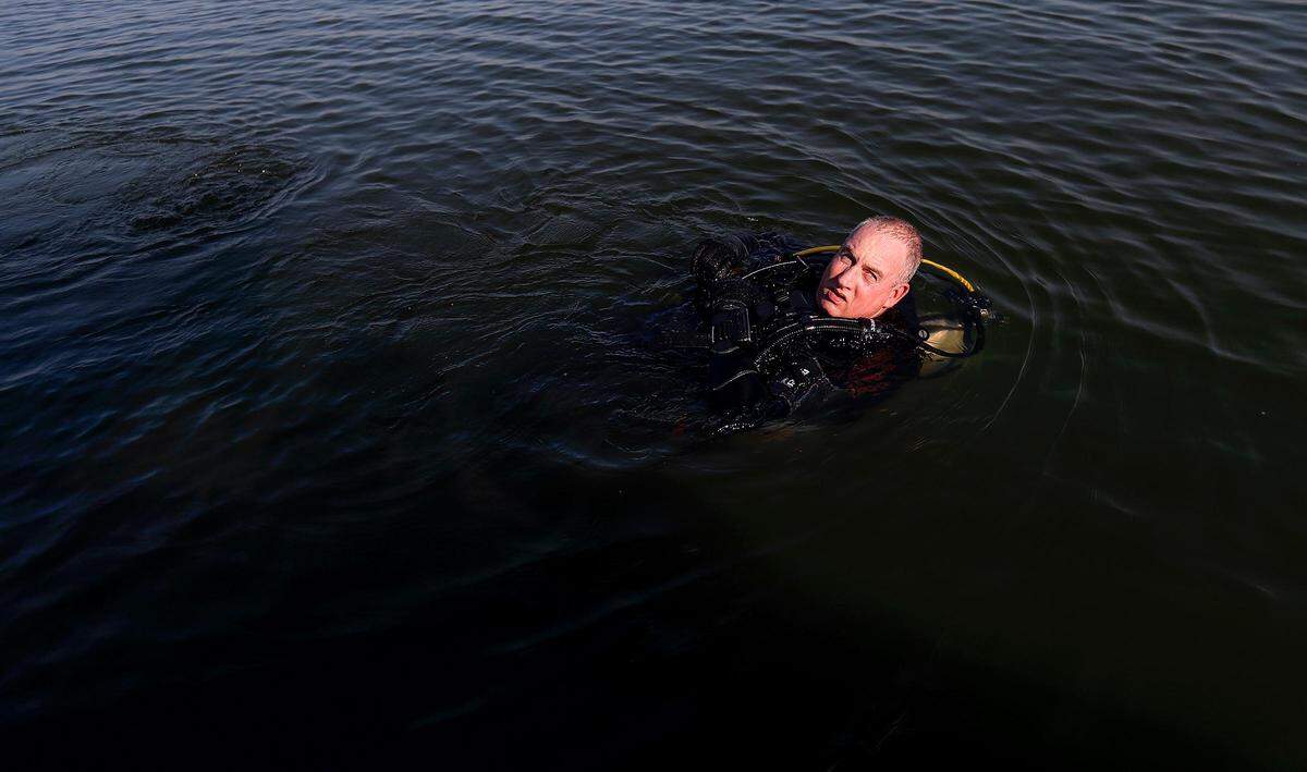 Diver Wayne Spears prepares to search for the third and final submerged car in Benbrook Lake, located over 30 feet underwater, on Monday, September 16, 2019. North Texas Marine Salvage & Recovery’s dive team volunteered to assist Rusty Arnold in retrieving the cars from the bottom of the lake in his search for clues to his sister’s 1974 disappearance.