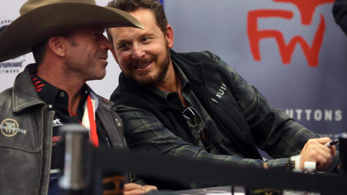 ‘Yellowstone’ actor Cole Hauser, right, leans in to take to screenwriter Taylor Sheridan while signing autographs at the Fort Worth Stock Show & Rodeo on Tuesday, February 1, 2022.