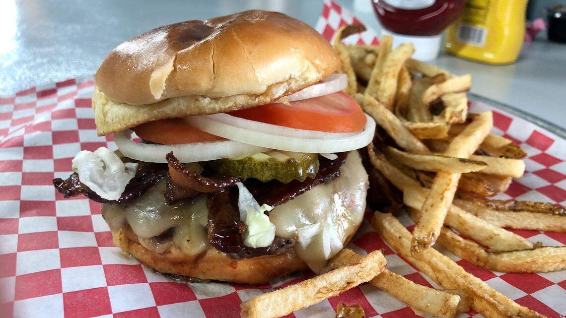 A regular “Herbie Burger” with brown sugar-bourbon bacon and fresh-cut fries at Herbie's in Arlington.