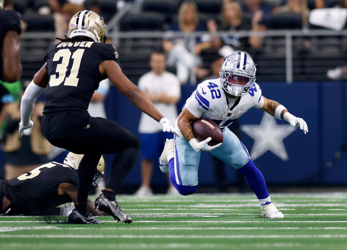 Dallas Cowboys running back Deuce Vaughn maneuvers down the field while being tracked by New Orleans Saints free safety Jordan Howden on Sunday, Sept. 15, 2024, at AT&T Stadium in Arlington.