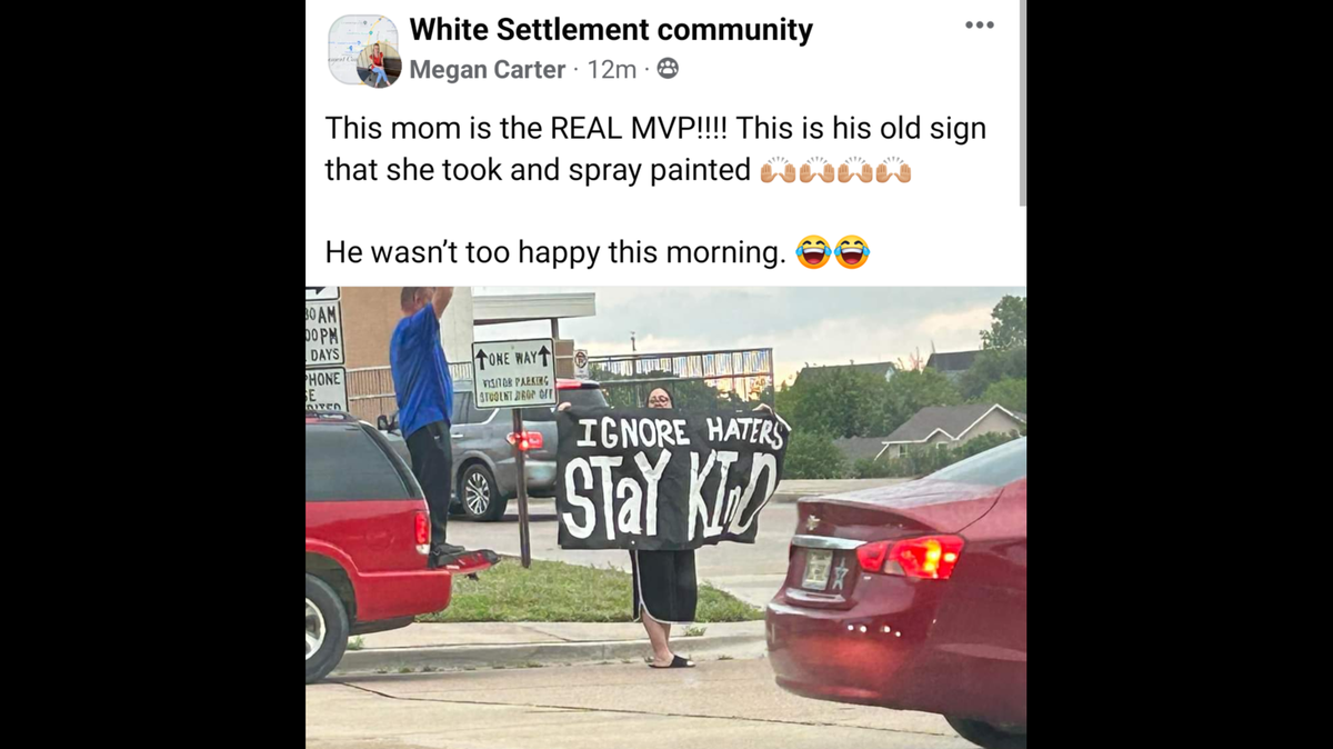 A screenshot of a Facebook post with an image of a woman holding a sign that reads "Ignore Haters. Stay Kind." The post reads "This mom is the real MVP. This is his old sign that she took and spray painted. He wasn't too happy this morning."