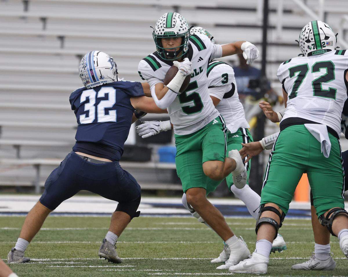 Southlake wide receiver Blake Gunter (5) gets past L.D. Bell outside linebacker Kole Martin (32) at a the line during the first half of a UIL football game between Carroll and L.D. Bell at Pennington Field in Bedford, Texas, Friday, October, 24, 2025.