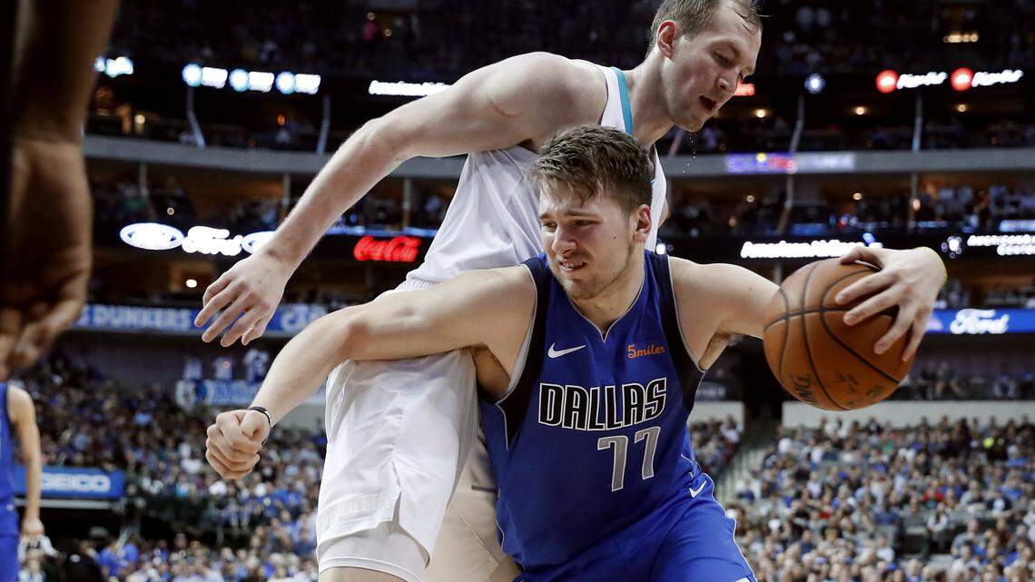 Charlotte Hornets center Cody Zeller (40) defends as Dallas Mavericks forward Luka Doncic (77) works to the basket during the second half of an NBA basketball game in Dallas, Wednesday, Feb. 6, 2019. (AP Photo/Tony Gutierrez)