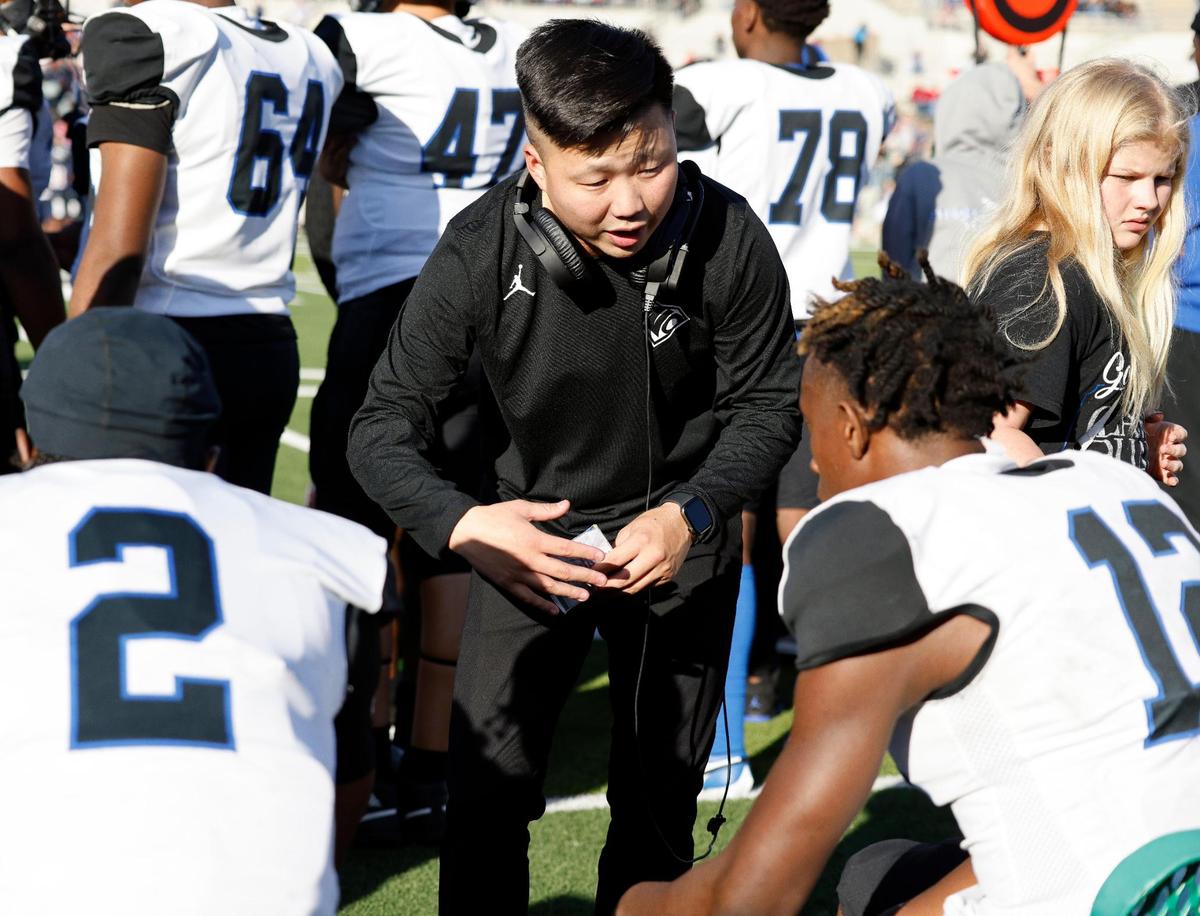 North Crowley offensive coordinator Eli Reinhart talks to quarterback Chris Jimerson (12) on the bench during the second half of a UIL Conference 6A Division 1 quarterfinal football playoff game at Dragon Stadium in Southlake, Texas, Saturday, Dec. 02, 2023.