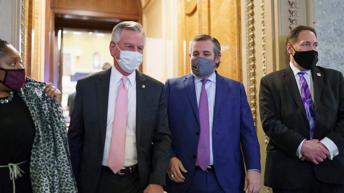 Sen. Tommy Tuberville, R-Ala., left, and Sen. Ted Cruz, R-Texas, leave the chamber Tuesday after taking an oath and voting on how to proceed on the impeachment against former President Donald Trump.