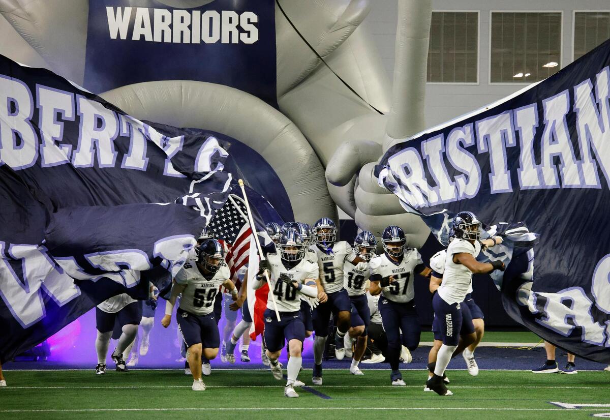 The Liberty Christian Warriors enter the field for the first half of a TAPPS Region 2 semi-final football playoff game at The Ford Center in Frisco, Texas, Saturday, Oct. 25, 2023.