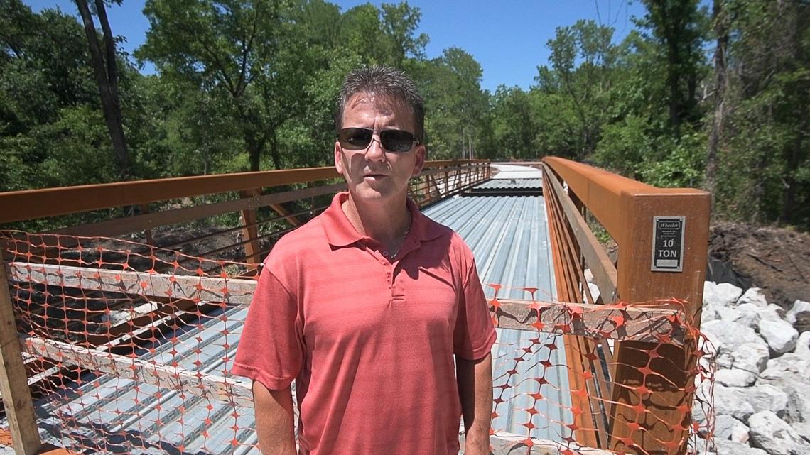 Arlington Park Planner and Landscape Architect Eric Seebock standing in front of one of the new bridges at River Legacy Trails in Arlington.