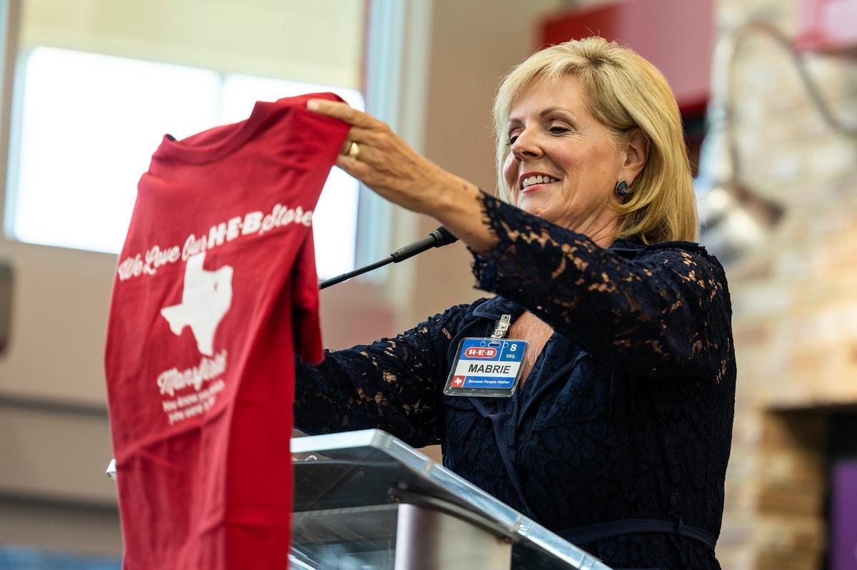 Mabrie Jackson, the Senior Director of Public Affairs for HEB, holds an HEB Mansfield shirt during the ribbon cutting ceremony for the new HEB location in Mansfield on Tuesday, June 25, 2024.
