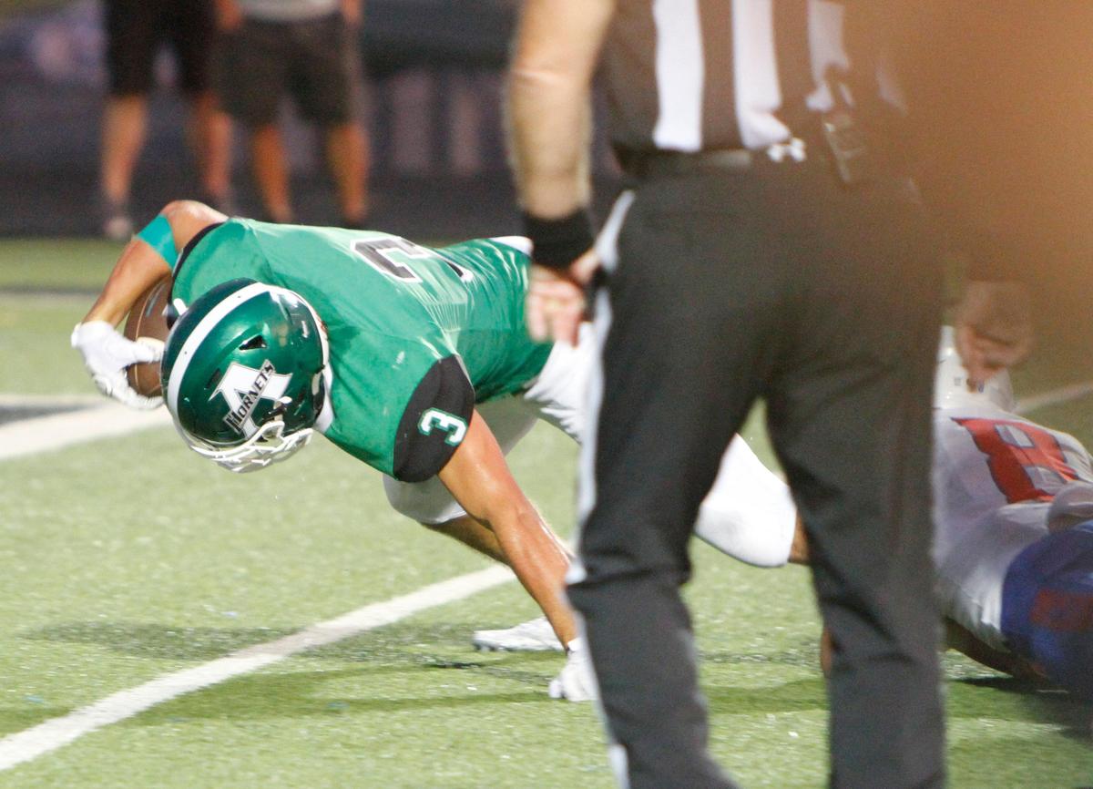 Azle’s Jacob Lee (3) lunges into the end zone for a first half touchdown, with Grapevine’s Jacob Shimkus (8) defending. The Grapevine Mustangs played the Axle Hornets on the opening night of Friday night football at Hornet Field in Azle, August 30, 2019.