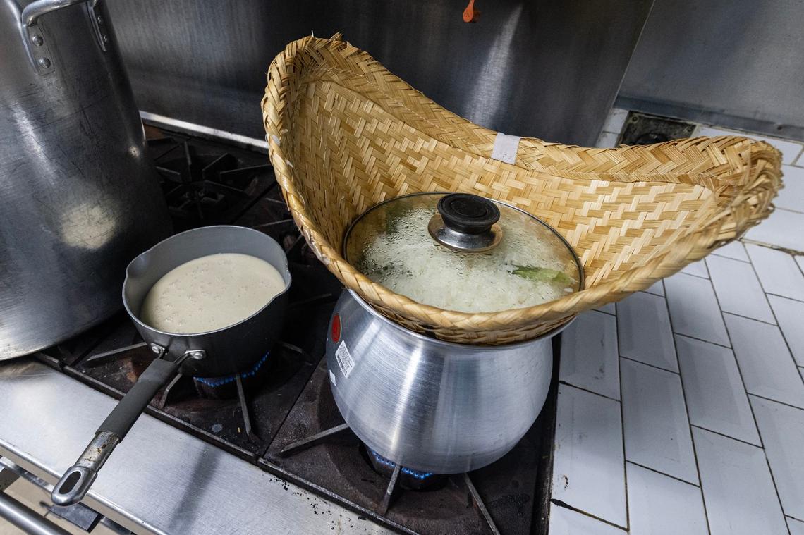 The coconut milk mixture heats on the stove next to the sticky rice cooking in a ‘Thip Khao’ for the rice served with the Lao sausage and mango with sticky rice. The phrase thip khao refers to a sticky rice steamer basket that is commonly used in Laos and diasporic communities.