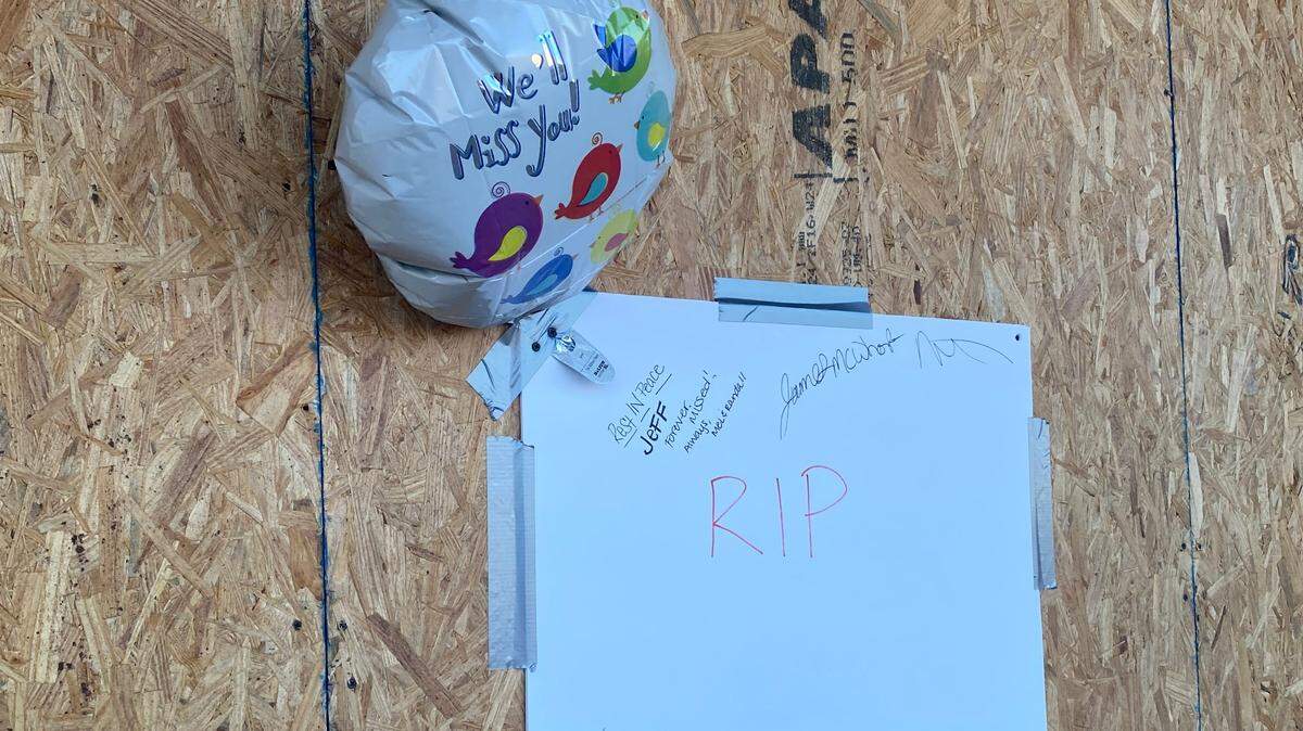 Employees and friends of a man who was killed when a truck drove through a game room Wednesday in Fort Worth put up this sign and balloon on the boarded-up window.
