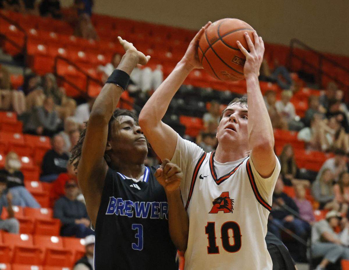 Aledo guard Caden Cunningham (10) gets a look defended by Brewer guard Braelon Orr (3) during the first half of a UIL boys basketball game at Aledo High School in Aledo, Texas, Friday Feb. 13, 2026.