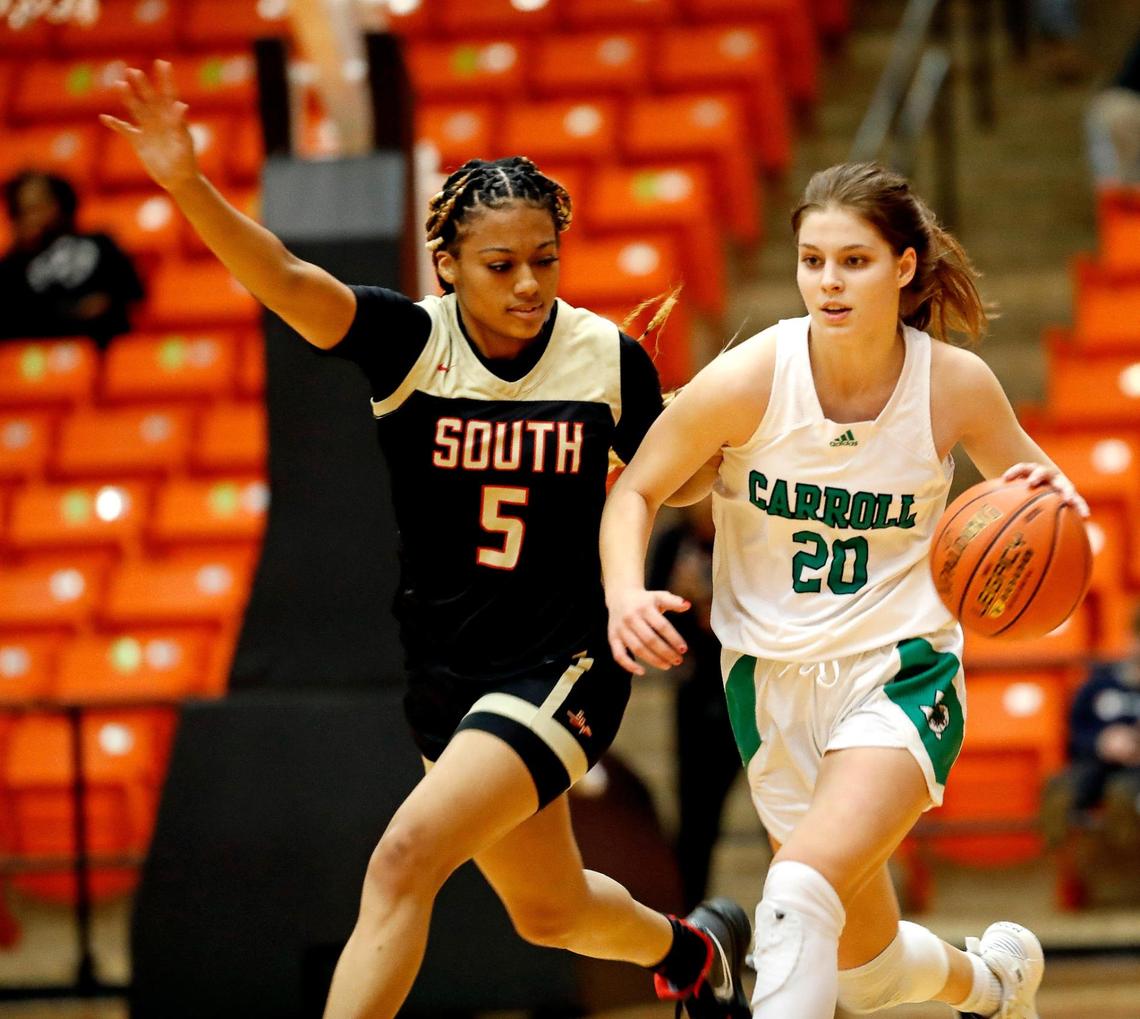 Carroll guard Camryn Tade (20) works against South Grand Prairie guard Jenny Handley (5) during the second half of a high school 6A Region 1Semi-final playoff basketball game at Wilkerson Greines Activity Center in Fort Worth, Texas, Friday, Feb. 25, 2022. SGP defeated Carroll 61-40. (Special to the Star-Telegram Bob Booth)