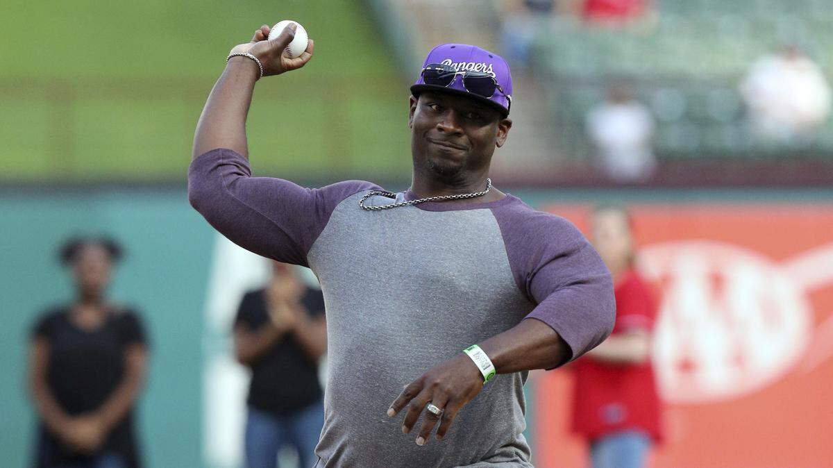 Pro Football Hall of Fame running back and TCU legend LaDainian Tomlinson throws out the ceremonial first pitch before Thursday's game between the Rangers and Red Sox at Globe Life Park.