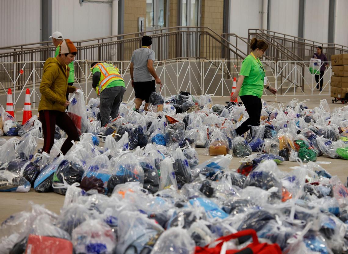 Volunteers look through runners personal possessions to hand them back at a check area during the 2025 Cowtown at the Will Rogers Memorial Center in Fort Worth, Texas, Sunday, Feb. 23, 2025.