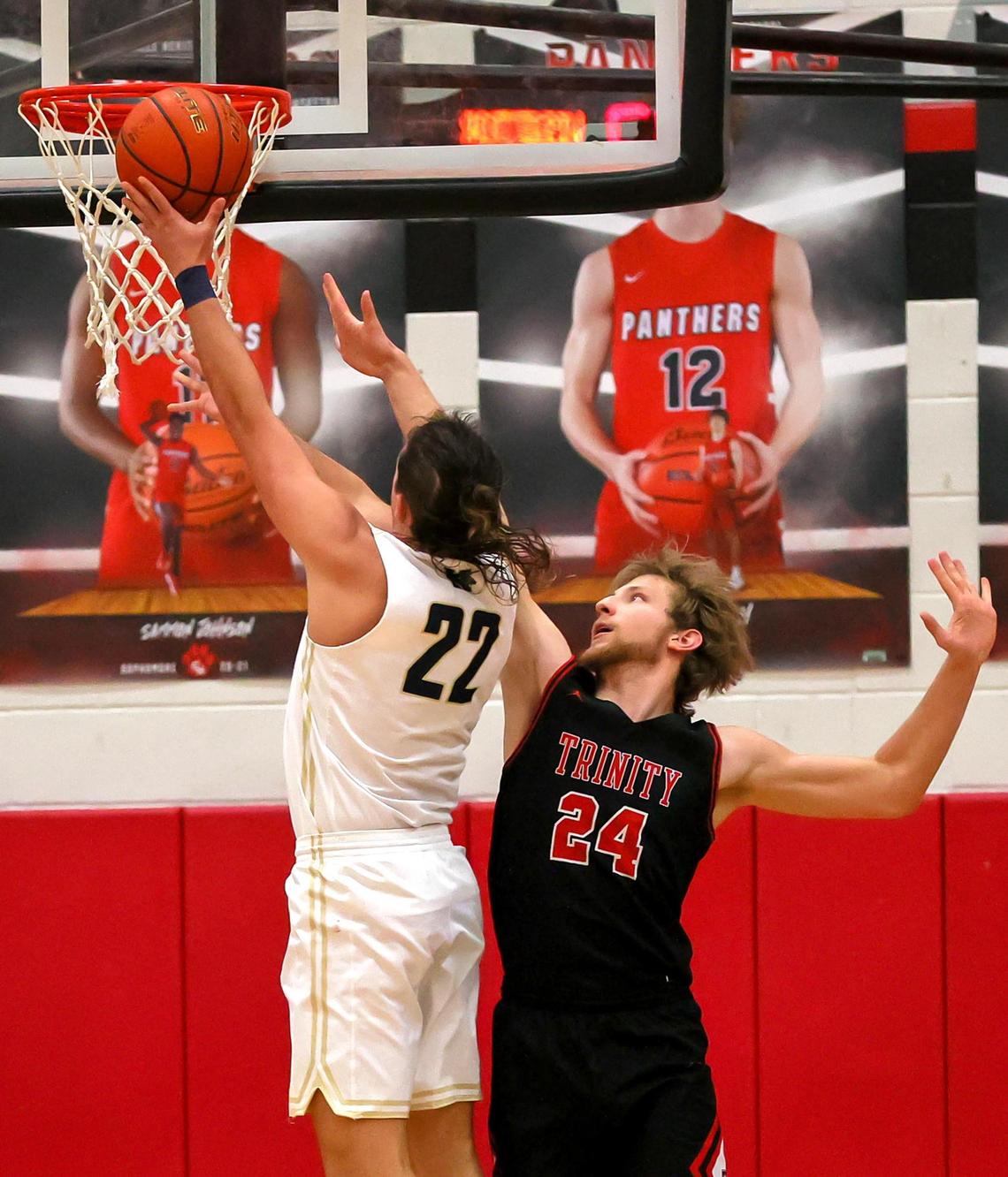 Keller forward Cole Roberts (22) goes in for two points against Trinity forward Jaxson Kapellusch (24) during the second half of a 6A Bi-District High School Basketball playoff game played Monday, February 22, 2021 at Colleyville Heritage High School. (Steve Nurenberg Special to the Star-Telegram)