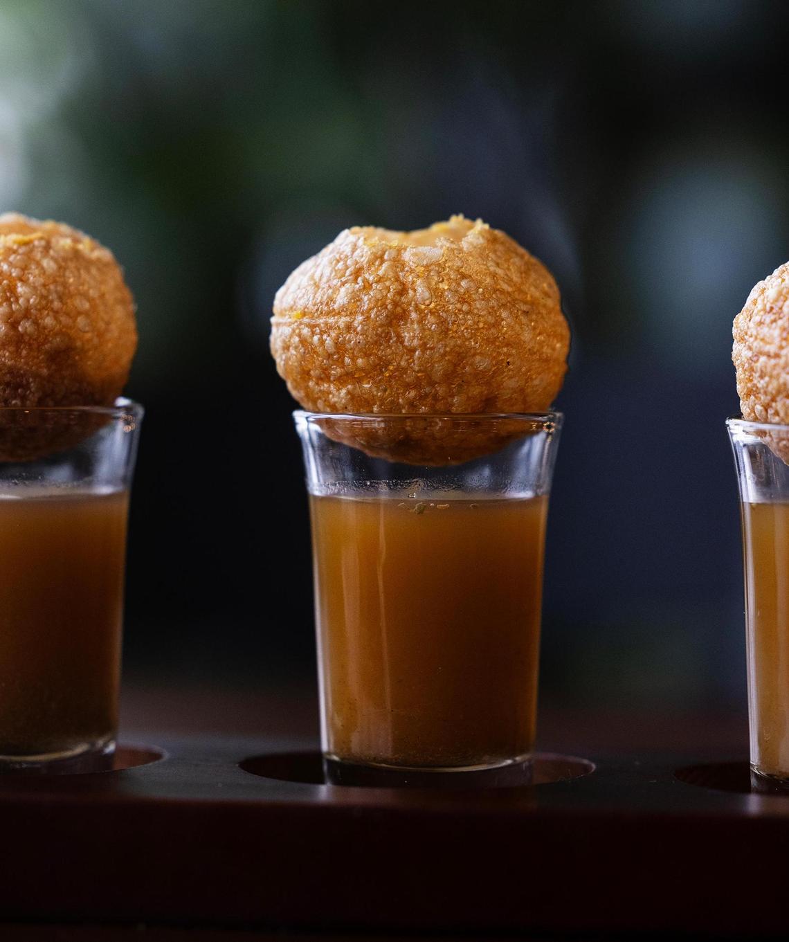 Pani Puri shots at Palate Garden Restaurant & Bar on Thursday, April 3, 2025, in Saginaw. Pani Puri is a popular street food that features a deep-fried hollow sphere filled with spiced potatoes and tamarind chutney. They are served cilantro water.