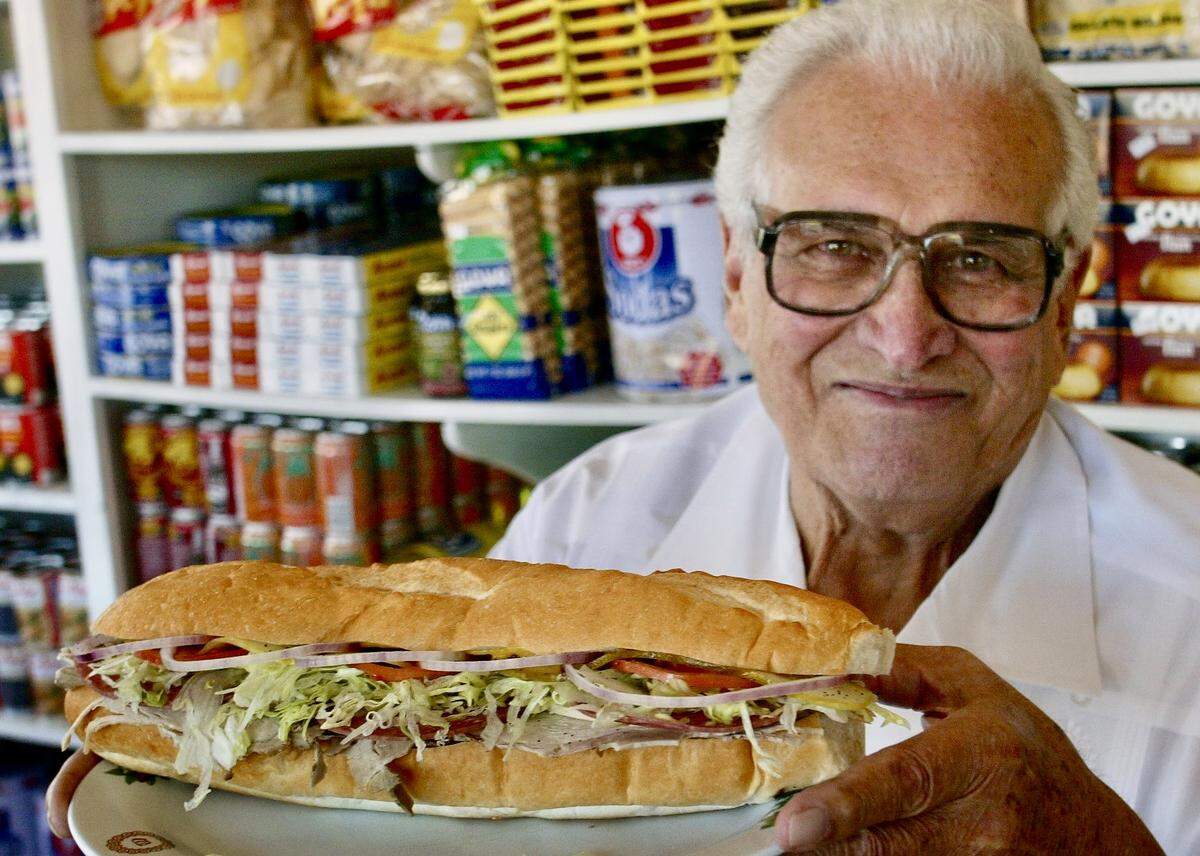 Julio Neira, co-founder of Cuco's Sandwich Shop in North Richland Hills, Texas, held up the "Deluxe" pressed sandwich on March 12, 2005. Neira died in 2007.