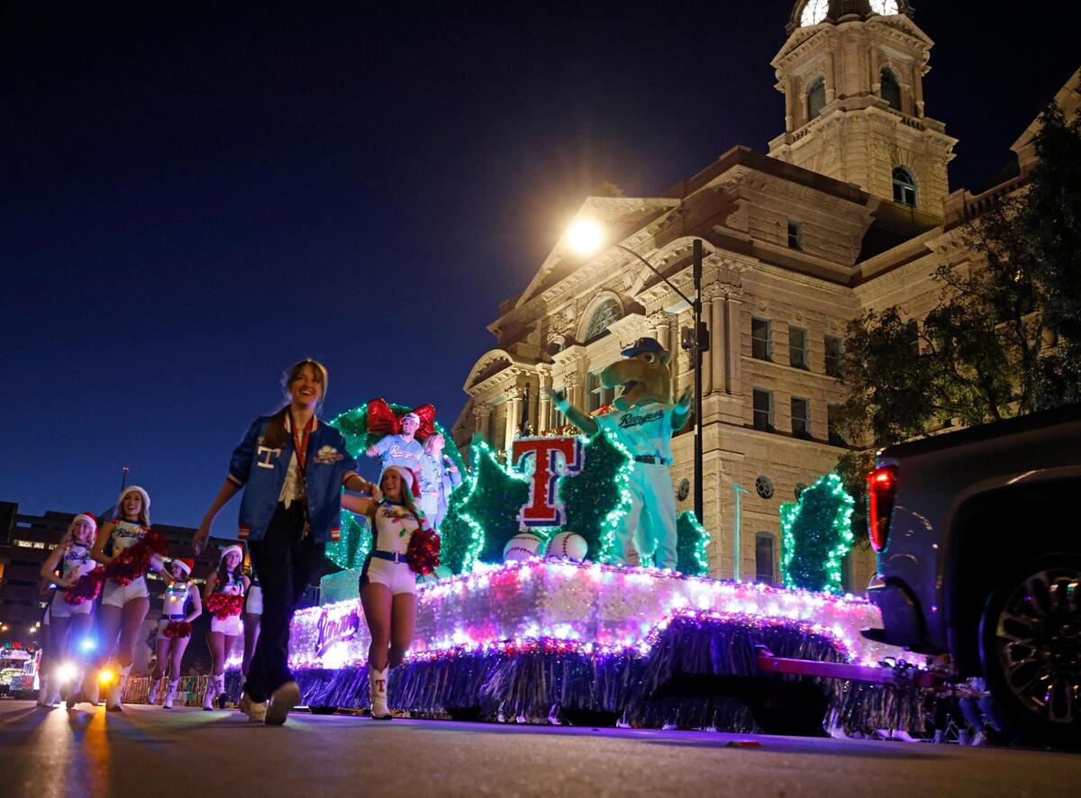 The 2024 Parade of Lights Grand Marshal Texas Rangers left fielder Evan Carter passes in front of the Tarrant County Courthouse in Fort Worth on Sunday.