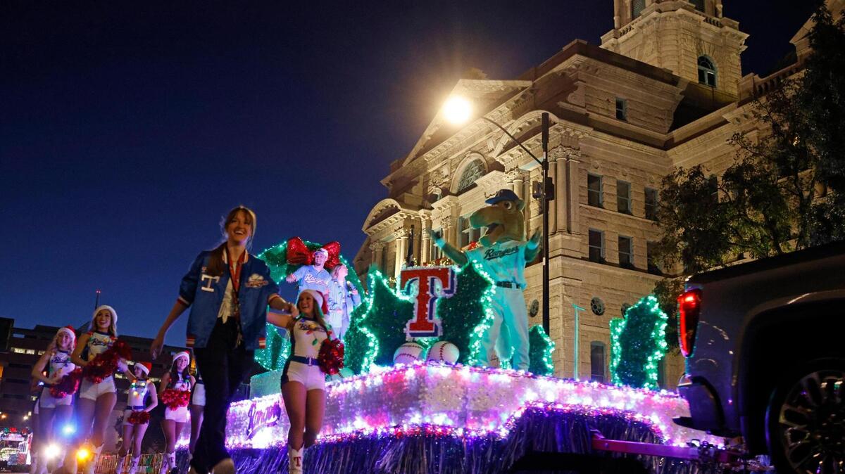 The 2024 Parade of Lights Grand Marshal Texas Rangers left fielder Evan Carter passes in front of the Tarrant County Courthouse in Fort Worth on Sunday.