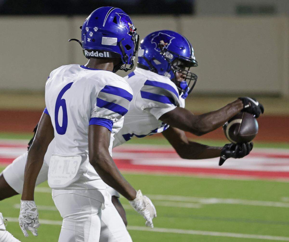 Dunbar free safety Dee Faulk (25) intercepts a pass intended for Benbrook wide receiver Waylin Barton (1) during the first half of a UIL football game between Benbrook and Dunbar at Herman E. Clark Stadium in Fort Worth, Texas, Friday, October 10, 2025.