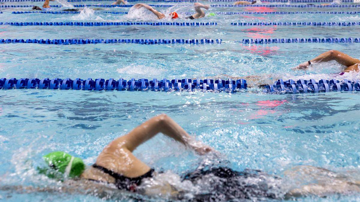 Swimmers pass each other in the lanes of the Keller ISD Natatorium during the Monster Triathlon on Oct. 18, 2015.