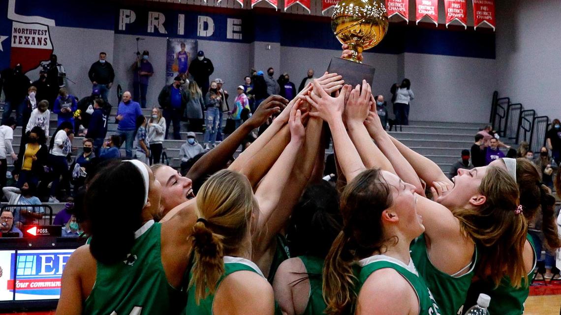 The Southlake Carroll Lady Dragons hold up their trophy after beating Keller Timber Creek, 40-27 in a 6A Region I Regional Quarter-Finals Girls Basketball playoff game played on Thursday, February 25, 2021 at Justin Northwest High School. (Steve Nurenberg Special to the Star-Telegram)