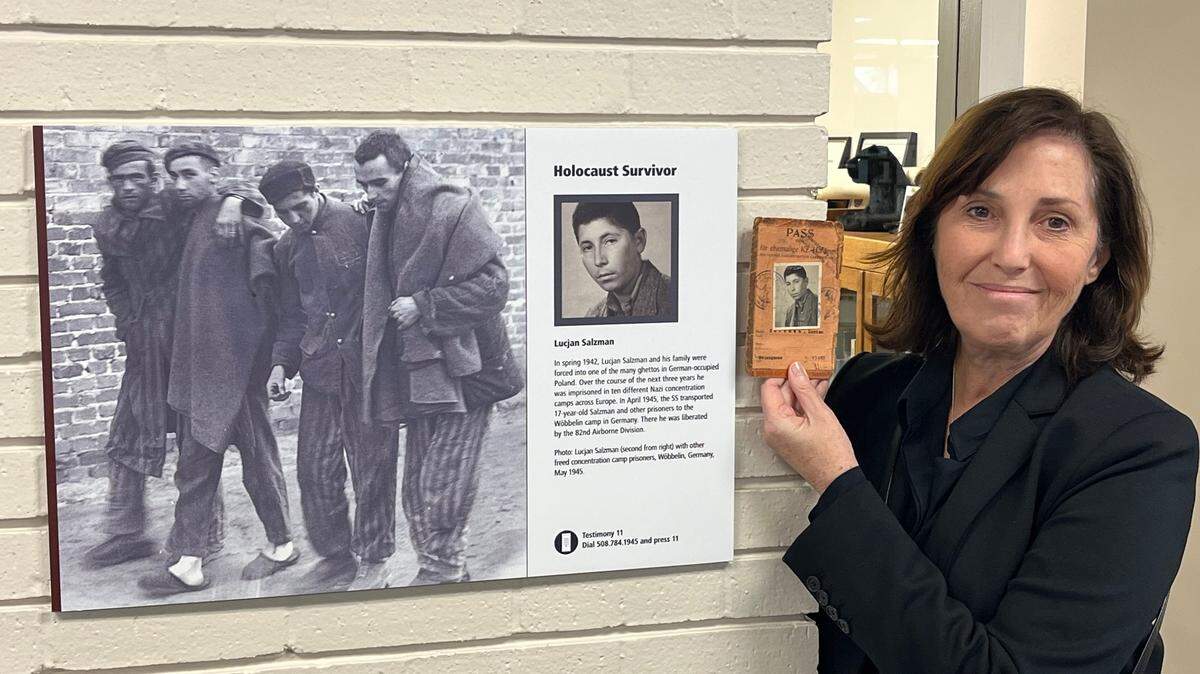 Anna Salton Eisen, right, holds the original picture of the pass her father received after he was liberated from a concentration camp in Germany. Eisen visited the Fort Worth History Center on Feb. 9 to see her father in the“American Witnesses” exhibit.