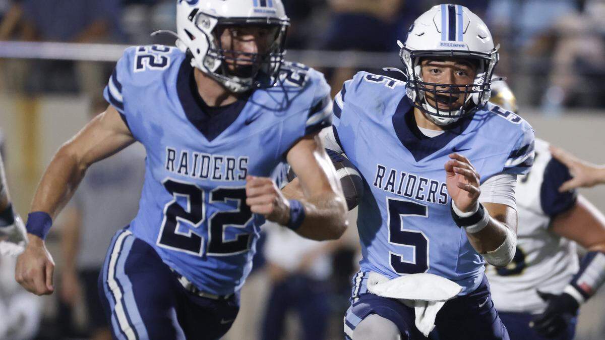 L.D. Bell quarterback Braylon Harris (5) follows his lead blocker running back Brendon Gleim (22) up the middle during the first half of a UIL football game between Keller and L.D. Bell at Pennington Field in Bedford, Texas, Friday, Sept. 19, 2025.