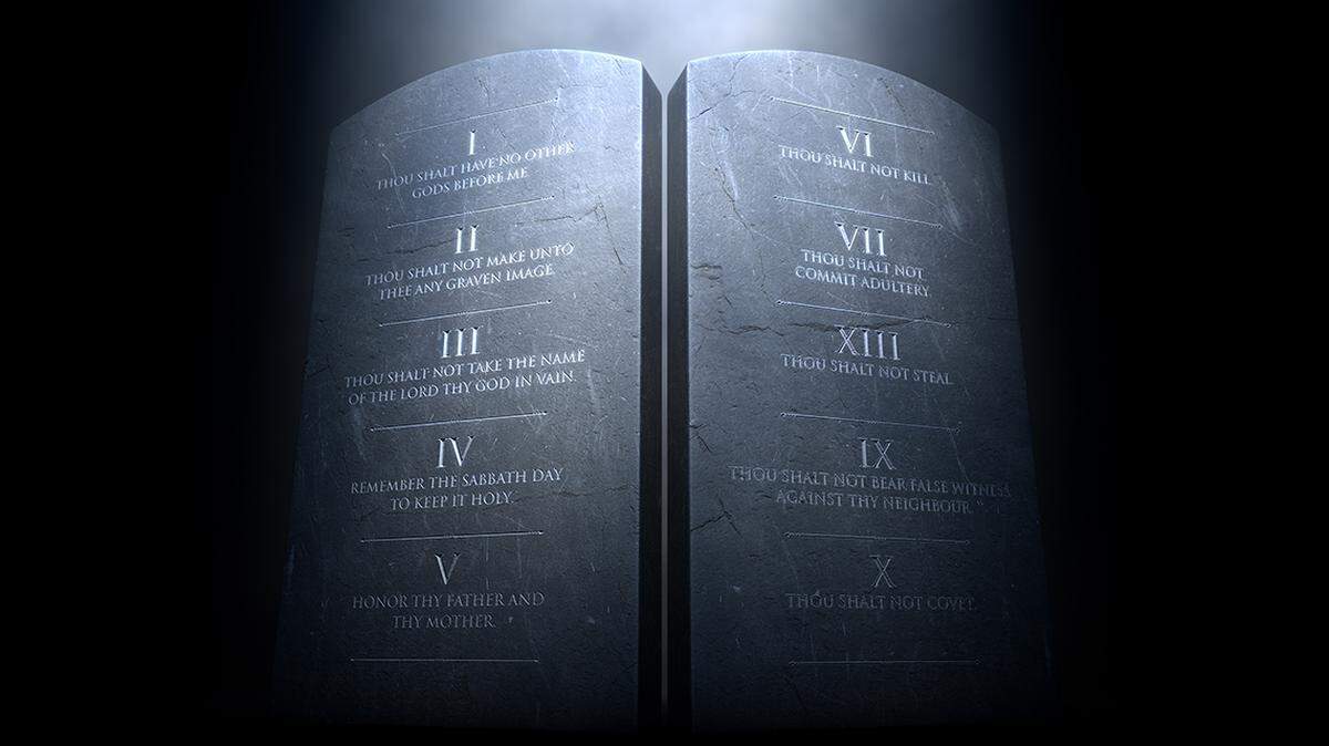 A 3D render of two stone tablets with the ten commandments etched on them lit by a dramatic spotlight on a dark background 10 commandments tablet