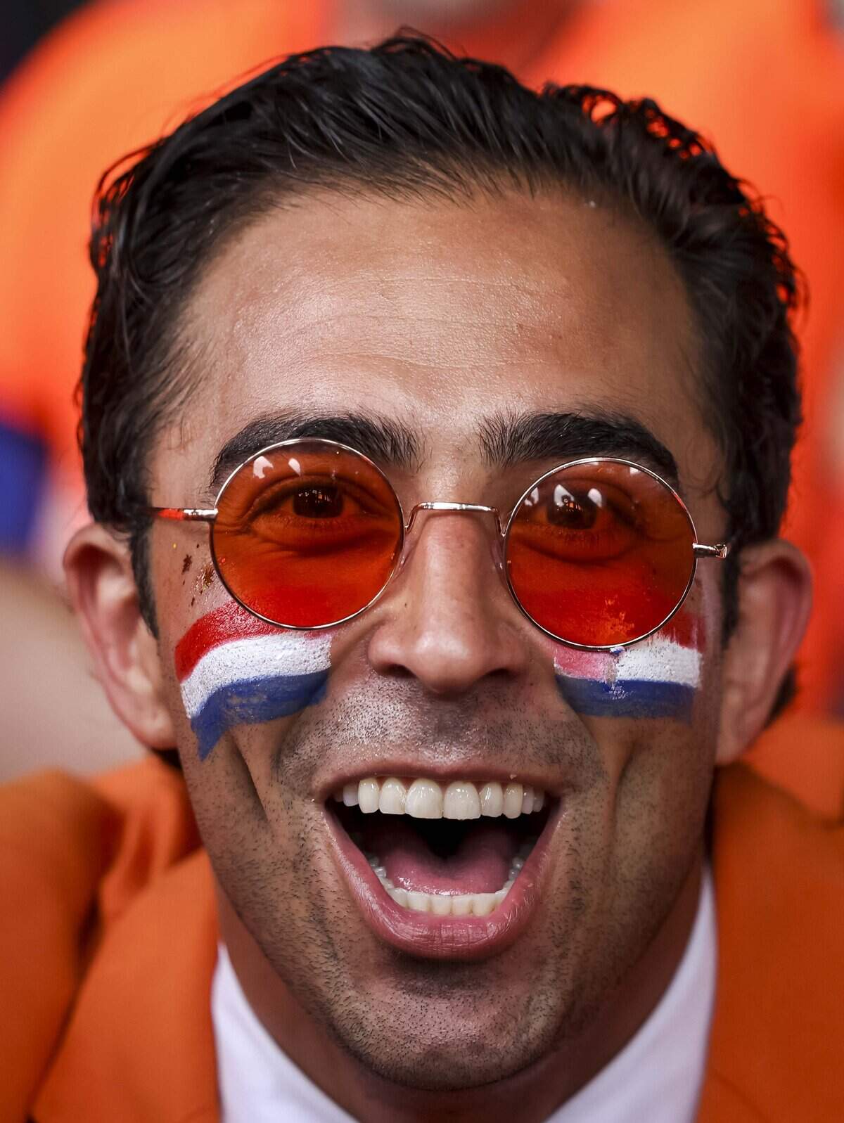 Daniel Oordt, the “Oranje Suit Man”, dances with other fans ahead of the orange fan walk on Sunday, June 14, 2026 in Arlington, Texas. The famous double-decker Dutch Orange Bus, or De beroemde Oranjebus, is part of a Netherlands fan tradition bringing a sea of orange to the streets before major soccer matches.