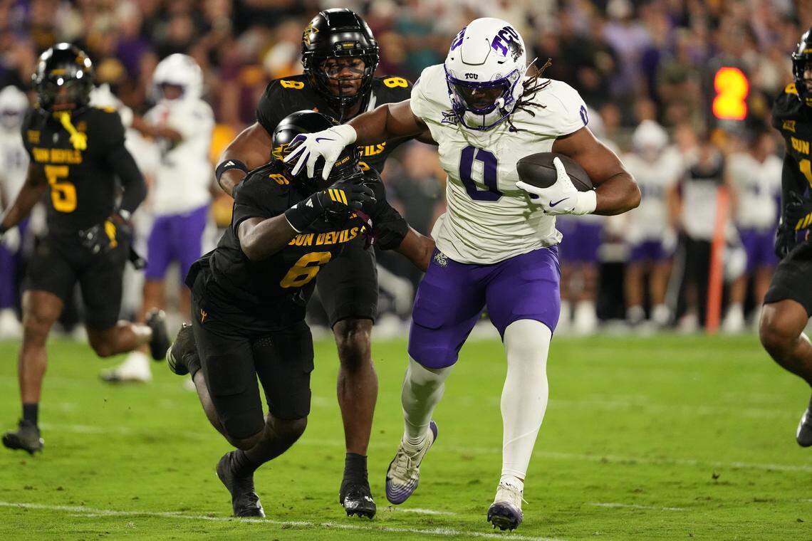 Sep 26, 2025; Tempe, Arizona, USA; TCU Horned Frogs tight end DJ Rogers (0) stiff arms Arizona State Sun Devils safety Adrian Wilson (6) in the first half at Mountain America Stadium, Home of the ASU Sun Devils. Mandatory Credit: Jacob Reiner-Imagn Images