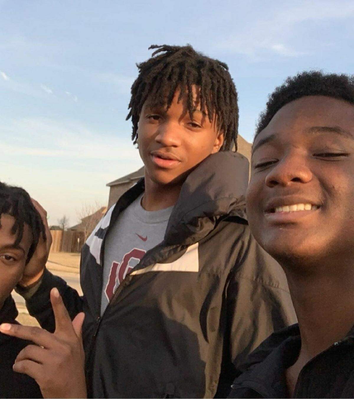Tre Allison (center), who was killed in a crash Monday night, looks at the camera for a photo with friends. Those who knew him said the 16-year-old Burleson High School student was a skilled football player as well as a good student and a kind friend.