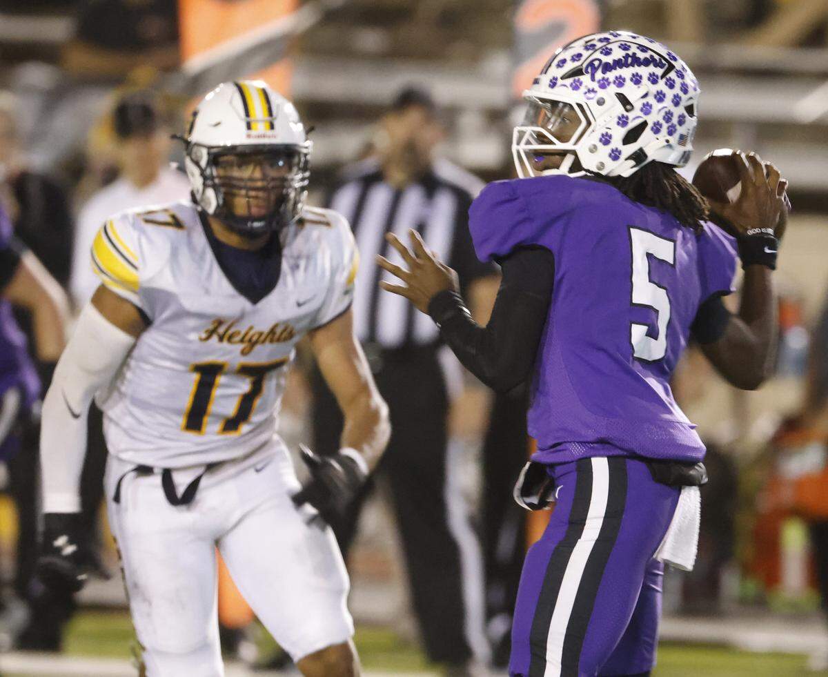 Arlington Heights linebacker Dino Walker (17) puts pressure on Paschal quarterback Jashaun Thomas (5) in the backfield during the first half of a UIL football game between Arlington Heights and Paschal at Farrington Field in Fort Worth, Texas, Friday Nov. 07, 2025.