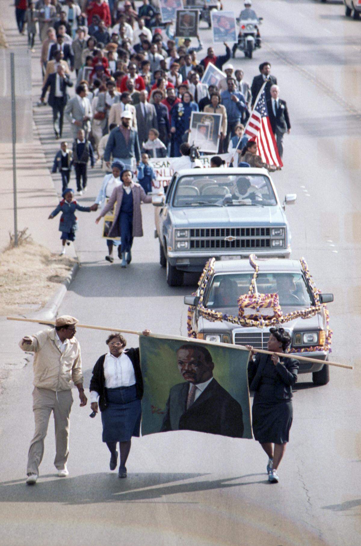 Jan. 15, 1986: A crowd of 150 marches along East Rosedale Street in Fort Worth in honor of civil rights leader Martin Luther King Jr. At front, Opal Lee, left, and Brenda Polk carry a painted banner depicting the likeness Dr. King.