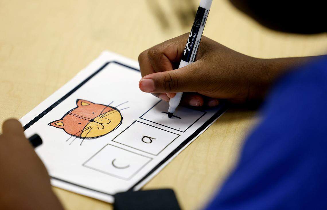 Second grader Malachi Murkledove works on writing words through sounding them out while tutoring with retired teacher Martha Farr at Westpark Elementary School on Thursday, Sept. 19, 2025. 